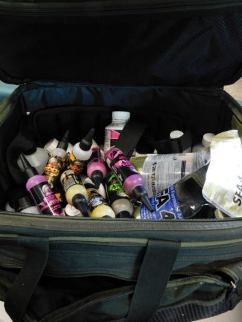 A Wychwood fishing luggage bag, containing a good assortment of fishing bait additives.