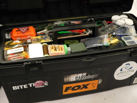 A large toolbox, with a collection of carp fishing accessories, including rig making equipment, pillars, cutters and a large selection of accessories.