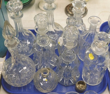 A quantity of 19thC and later decanters, stoppers, etc., to include a silver topped jar.