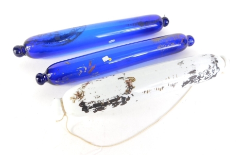 A blue glass souvenir rolling pin, with indistinct decoration of a bridge, etc., another similar decorated with a boat, and a white opaque glass rolling pin. (3)