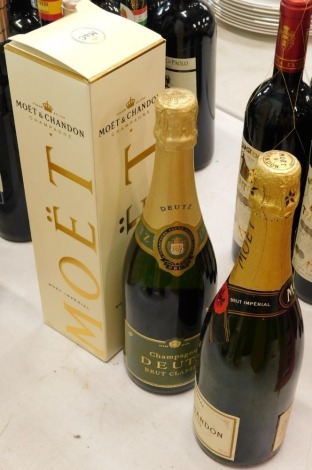 A bottle of Moet and Chandon Imperial Champagne, (boxed), another bottle of Moet and Chandon Champagne, and a bottle of Deutz Champagne.