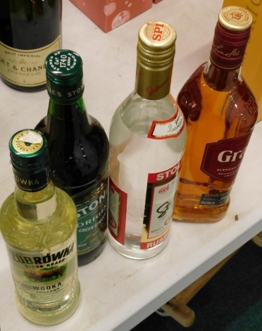 A bottle of Grant's Triple Wood blended Scotch Whisky, two bottles of Vodka, and a bottle of Stone's Green Ginger Wine. (4)