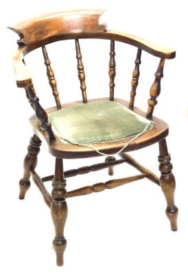 An ash and elm captain's chair, with padded seat, on turned legs with H stretcher.