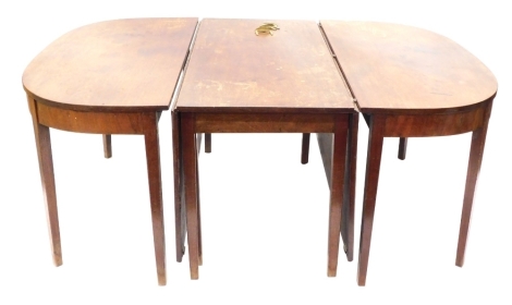 A George III mahogany extending dining table, comprising two D-ends and a central drop leaf section, on square tapering legs, 70cm high, 122cm wide, 289cm long.