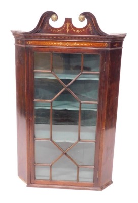 A 19thC mahogany hanging corner cabinet, the swan neck pediment later painted in Sheraton style with swags, above a astragal glazed door, 119cm high, 70cm wide.