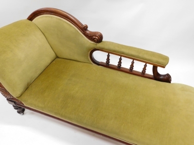 A late Victorian mahogany chaise lounge, upholstered in green fabric, on turned legs with later castors. - 2