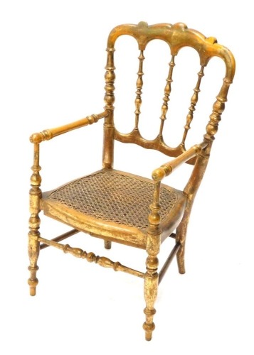 A giltwood child's chair, with caned seat, on turned supports.