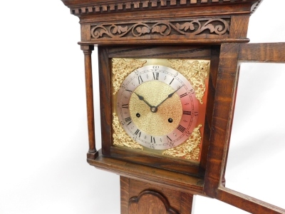 An oak grandmother clock, the hood with blind fret and dentil frieze above a brass stile flanked by cylindrical turned pillars, the trunk with an arched panel door, on bracket feet, 167cm high. - 2