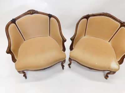 A pair of 19thC French mahogany show framed armchairs, upholstered in beige fabric on cabriole legs with castors. - 2