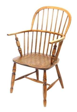 A 19thC ash and elm Lincolnshire low back Windsor chair, with plain spindles, signal turned front legs joined by a H stretcher, probably Stamford