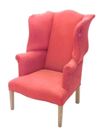 A 19thC wing armchair in red scroll floral material on square tapering front legs, 113cm high.