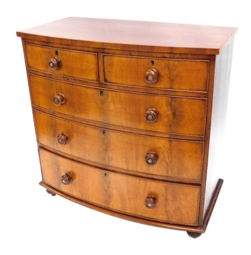 A Victorian mahogany bow front chest, of two short and three long drawers.