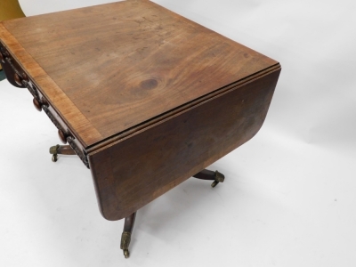 A 19thC mahogany sofa table, with a wide crossbaning and frieze drawers, on a platform base, terminating in sabre legs. - 2