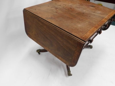 A 19thC mahogany sofa table, with a wide crossbaning and frieze drawers, on a platform base, terminating in sabre legs. - 3