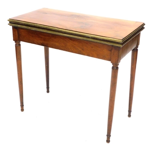 A 19thC continental mahogany card table, the rectangular top with a moulded brass border, above a plain frieze, on turned tapering legs, 73cm high, 81cm wide.