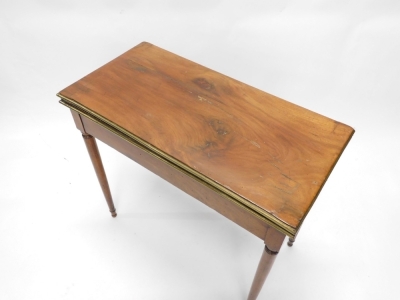 A 19thC continental mahogany card table, the rectangular top with a moulded brass border, above a plain frieze, on turned tapering legs, 73cm high, 81cm wide. - 2