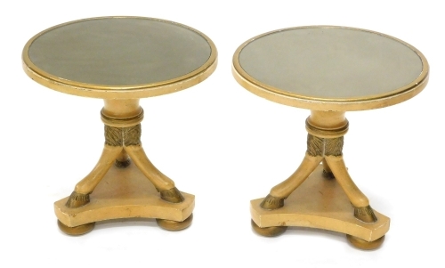 A good pair of glass topped torchere tables, in the Regency style, the circular tops on triple hoof supports and platform bases terminating in compressed bun feet, 44cm high, 51cm diameter. (2)