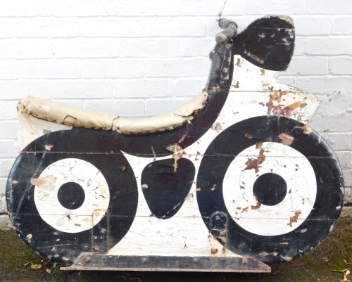 A fairground ride wooden motorcycle, painted in white and black, on metal framed base with metal handles, various coloured leather studded seat, 94cm high, 112cm wide, 40cm deep. (AF)