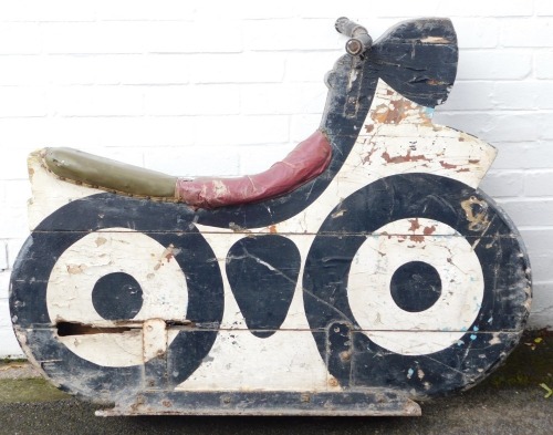 A fairground ride wooden motorcycle, painted in white and black, on metal framed base with metal handles, various coloured leather studded seat, 94cm high, 112cm wide, 40cm deep. (AF)