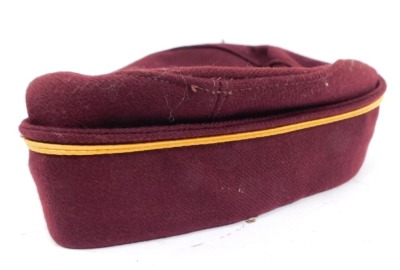 A railway conductor's cap, in maroon with gold border and applied railway badge, numbered 28/321GN. - 2