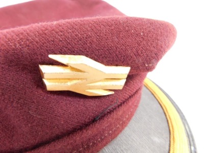 A railway conductor's cap, in maroon with gold border and applied railway badge, numbered 28/321GN. - 4