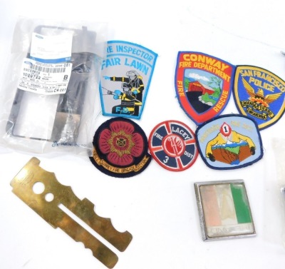 A group of motor racing badges, comprising San Francisco Police, Fire Inspection, Surrey Fire Brigade Drill Section, a Ford domestic bezel part, various fire and rescue badges, a Rover car badge, etc. (a quantity) - 2