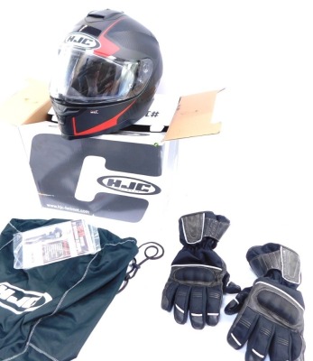 A HJC motorcycle helmet, boxed, with carry bag and gloves.