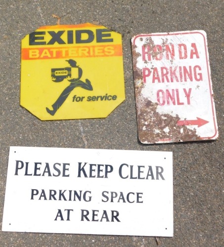 Three tin signs, comprising Honda Parking Only, on a white ground with red writing, 46cm x 31cm, an Exide Batteries yellow service sign, 42cm x 43cm, and a Keep Clear Parking Space At Rear metal sign, white ground, 31cm x 61cm. (3, AF)