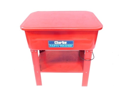 A Clarke's Part Washer, in freestanding metal frame in red.