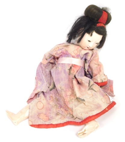 A semi porcelain Geisha doll, with articulated limbs, in flowing silk robes with headband, 50cm high.