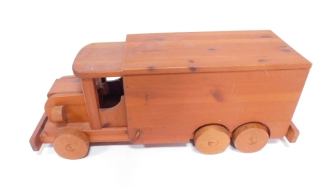 A pine child's push along truck, with lift lid compartment.