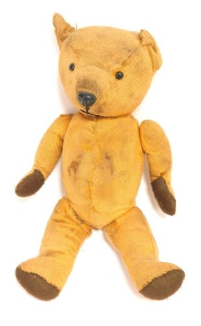 A mid 20thC blonde plush jointed Teddy bear, with brown felt pads, black eyes, 35cm high. (AF)