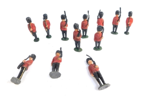 Twelve painted lead soldiers, each as Queen's guard in red overcoat with black hats and rifles.