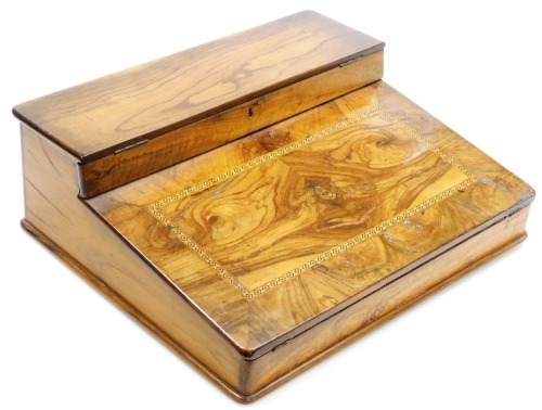 A Victorian olive wood and inlaid writing slope, the hinged top opening to reveal a fitted interior, with inkwell, and a fall flap opening to reveal a purple velvet writing slope and vacant interior, 40cm wide, 33.5cm deep.