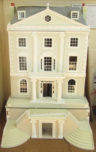 A substantial Georgian style doll's house, with white and grey painted brick finish, with swing steps over three tiers, 157cm high, 104cm wide, 92cm deep.