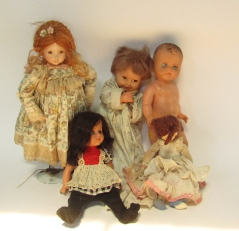 Various dolls, to include a celluloid example, cloth jointed doll with red cheeks, 26cm high, porcelain doll on stand, etc. (a quantity)