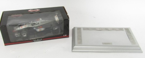 A McLaren Collection 1:18 scale Mini Champs Mika Hakkinen racing car, partially boxed, with presentation plaque. (2)