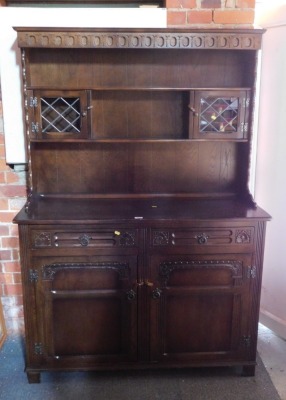 A dark oak effect Stanley Wood Ltd dresser with plate rack.