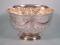 A small silver punch bowl with part fluted decoration and embossed with