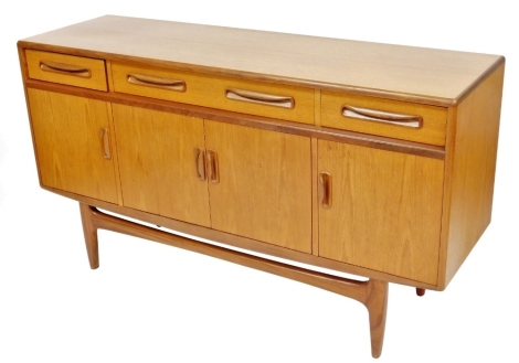 A mid century G-Plan teak sideboard, one long fitted and two short drawers, over four cupboard doors, raised on tapering square legs, 84cm high, 151cm wide, 45.5cm deep.