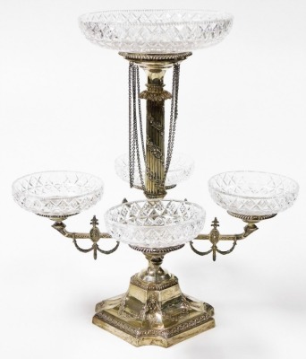 A Victorian silver and cut glass centrepiece epergne, the central fluted column embossed with floral garlands, supporting a cut glass dish in a silver recess with chain link drops above a semi fluted baluster vase with four extending arms, embossed with s - 2