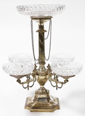 A Victorian silver and cut glass centrepiece epergne, the central fluted column embossed with floral garlands, supporting a cut glass dish in a silver recess with chain link drops above a semi fluted baluster vase with four extending arms, embossed with s - 3