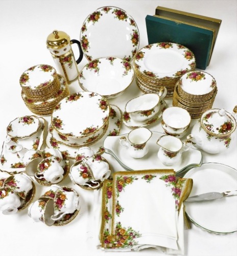 A Royal Albert porcelain dinner and tea service, decorated in the Old Country Roses pattern, few seconds, comprising a pair of oval serving dishes, flan dish, salad bowl, sauce boat on stand, fifteen dinner, twelve dessert and thirteen side plates, twelve