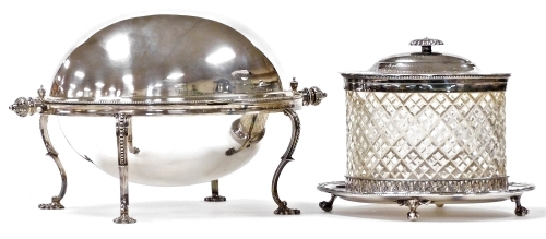 A Victorian cut glass biscuit barrel, with plated mount and hinged lid, engraved with flowers and ferns, on a galleried oval plated stand, raised on ball and claw feet, 21cm wide, together with a Victorian silver plated entree dish, with domed cover, rais