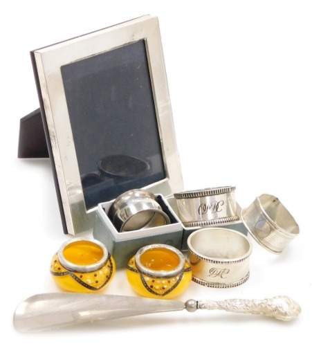 A group of small silver, to include a silver framed photograph frame, Sheffield 2004, 15cm X 11.5cm, various napkin rings, a silver handled shoe horn, etc, weighable silver 3½oz. (a quantity)