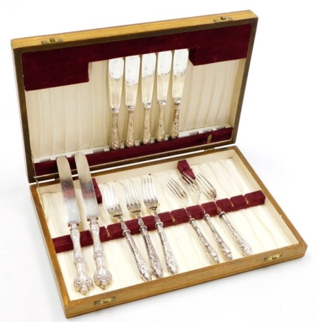 A late Victorian part set of silver handled fish knives and forks, comprising six forks and five knives, each handle profusely decorated with leaves, and two further butter knives of differing design, in fitted case.