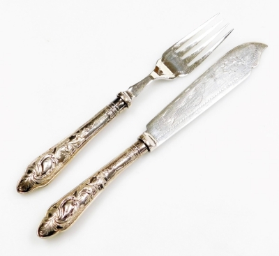 A late Victorian part set of silver handled fish knives and forks, comprising six forks and five knives, each handle profusely decorated with leaves, and two further butter knives of differing design, in fitted case. - 2