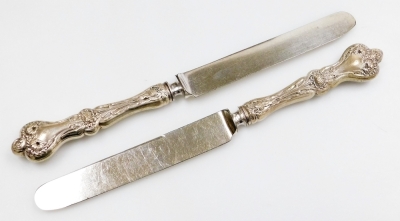 A late Victorian part set of silver handled fish knives and forks, comprising six forks and five knives, each handle profusely decorated with leaves, and two further butter knives of differing design, in fitted case. - 4