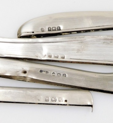 A set of six George V silver Old English pattern coffee spoons, Birmingham 1918, and four strips of silver, differing lengths, possibly removed from photograph frames, 5½oz gross. - 2