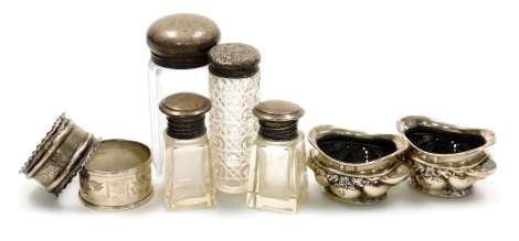 A group of small silver, to include a pair of Edward VII open salts, decorated with leaves, swags, etc, Birmingham 1902, 6cm wide, various silver topped glass dressing table bottles, napkin rings, etc, weighable silver 3¼oz.